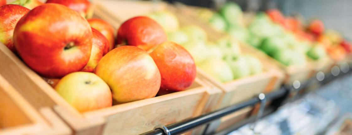 Box with fruits on stand in food store, nobody